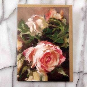 
                  
                    Load image into Gallery viewer, Bouquet of Roses Greeting Card features a bouquet of classic peachy tinted roses clustered with a single red bloom resting near a pair of candlesticks.  Card front, 7&amp;quot;x5&amp;quot; featured with Kraft envelope inside a protective plastic sleeve. 
                  
                