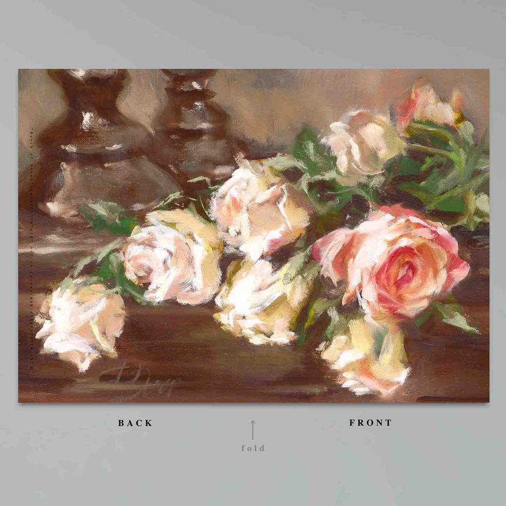 
                  
                    Load image into Gallery viewer, Bouquet of Roses Greeting Card features a bouquet of classic peachy tinted roses clustered with a single red bloom resting near a pair of candlesticks.  Card front and back, 7&amp;quot;x10&amp;quot; shown against a grey ground 
                  
                