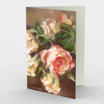 Bouquet of Roses Greeting Card features a bouquet of classic peachy tinted roses clustered with a single red bloom resting near a pair of candlesticks.  Card front, 7"x5" , blank inside
