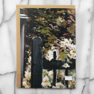 
                  
                    Load image into Gallery viewer, Gate entering into a luscious English garden with profusion of flowers against a leafy background. Back view shown with Kraft envelope in a protective plastic sleeve.
                  
                